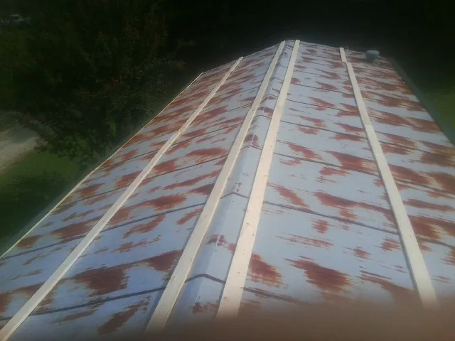 Rusted metal roof panels with new wood purlins before replacement — Storm Damage Roof Repair in Brewer by Roofing Brothers