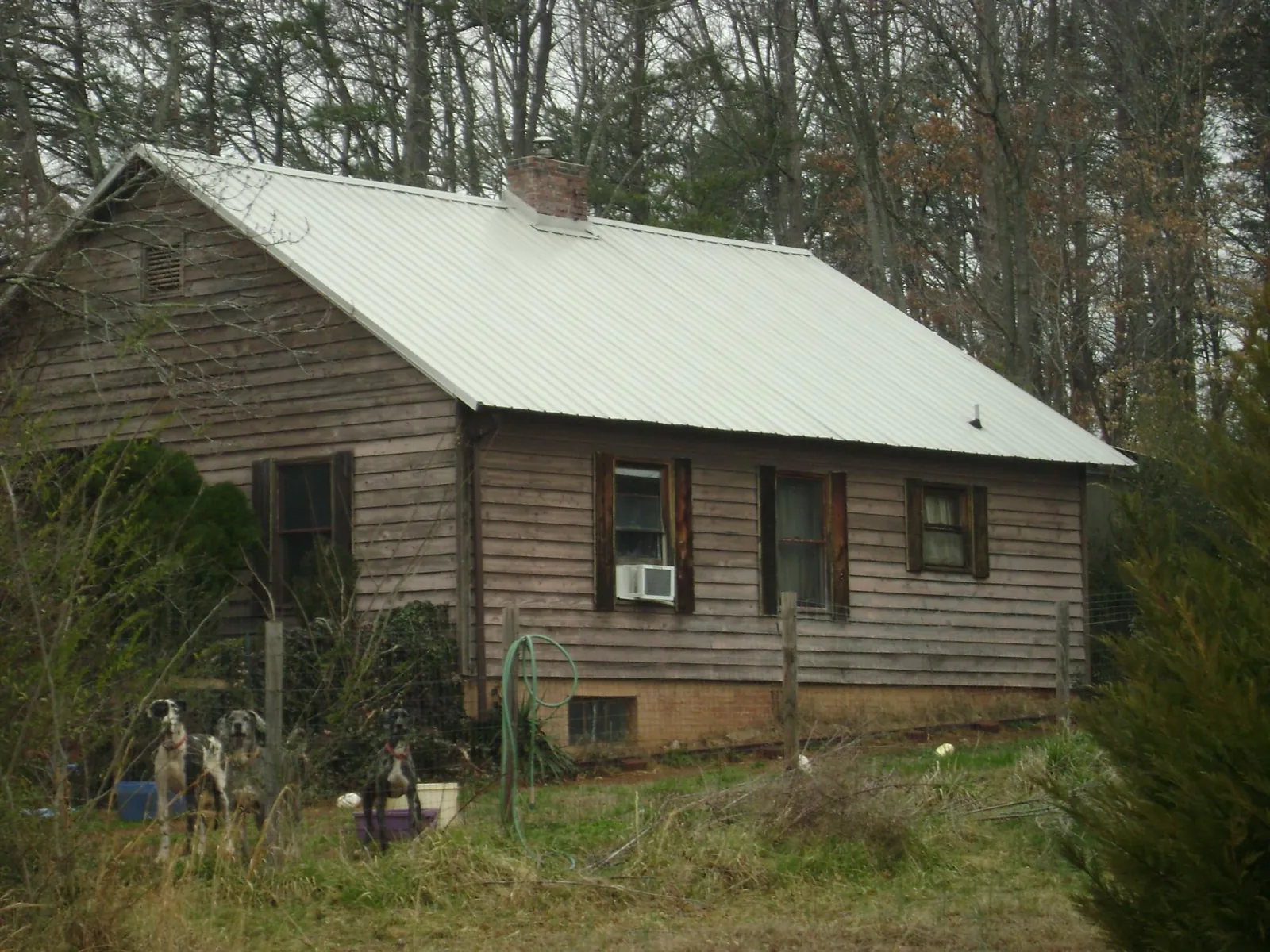 White metal roof on an old wood sided farmhouse, from a Metal Roof Installation job in Brewer